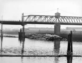 [A "Davis" raft of logs under the Cambie Street Bridge]