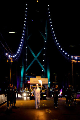 Day 106 Torchbearer 5 Mac Stewart carries the flame across the Lions Gate Bridge in Vancouver, Br...