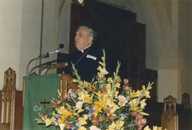 Priest speaks from podium at St. Andrew's Wesley Church