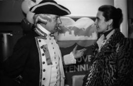 Actor wearing Captain George Vancouver costume talking to unidentified woman