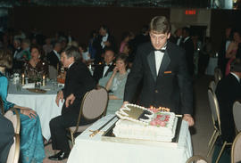 Man bringing in cake during Centennial Ball at the Pan Pacific Hotel