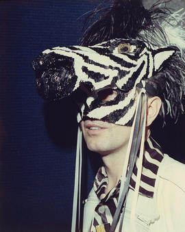 Robert Pogue wearing a sequined zebra mask