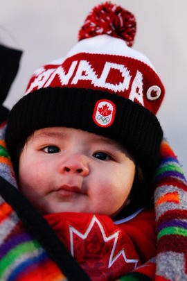 Day 81 Young child shows wears Canada clothing to greet the flame in Kainai, Alberta.