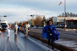 Day 8 Fort McMurray, AB RBC volunteer runs along with the flame.