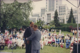 Mike Harcourt and unidentified man on Chevron Stage