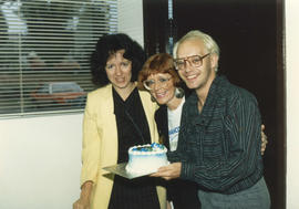 Centennial staff holding a cake