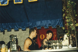 Two bartenders working at unidentified bar