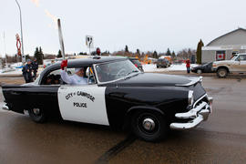 Day 78 Torchbearer 88 Boris Rybalka carries the torch on board of old police card in Camrose, Alb...