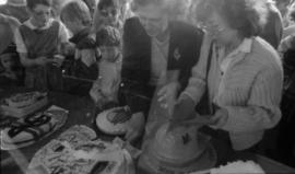 Women serving birthday cake