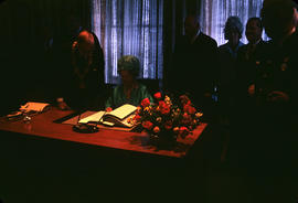 Queen Mother signing book [Aeneas Bell-Irving witnessing]