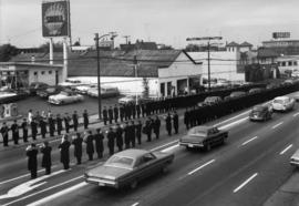 [View of funeral procession of Don McCavour on Kingsway with firefighters lined on road]