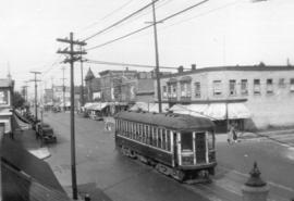 [View looking north along Commercial Drive at 2nd Avenue from an apartment on the southwest corner]