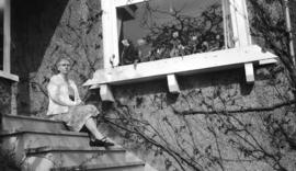 [Portrait of Mrs. W.H.G. Willis sitting on the steps outside Major J.S. Matthews' house in Kitsil...