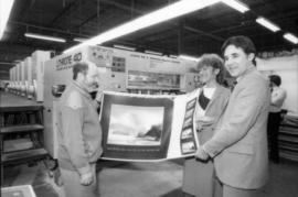 Toni Onley, unidentified woman and Robert Dubberley hold up Centennial Art Series print