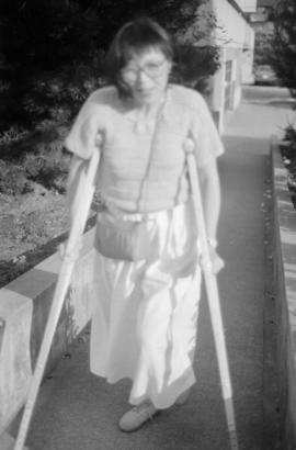 Judy M. Chan walking with the aid of crutches