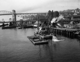 Excavation for pier M7. Floating clamshell dredge and scow