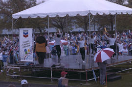 Tillicum and fitness instructors lead group exercise from Chevron Stage