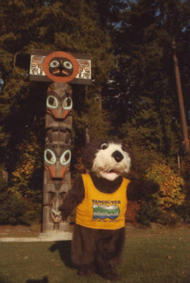 Tillicum in front of totem poles at Brockton Point