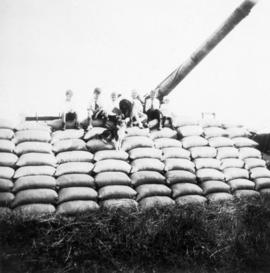 Pile of grain sacks [with children sitting on it]