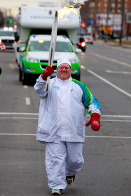 Day 52 The Relay Super Fan Torchbearer 40 Neil Earl carries the flame in Stoney Creek, Ontario.