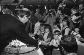 Mike Harcourt serving birthday cake