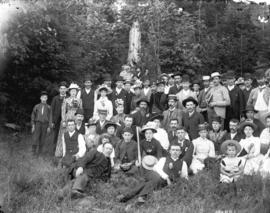 [Men, women and children assembled near Tom Turner's orchard for picnic]