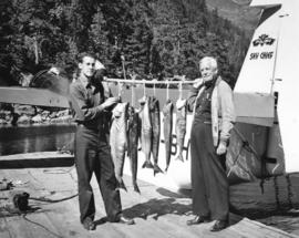 [B.J. Bradner with the fish he caught and Ray Kay on the dock of the Malibu Club]