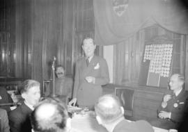 [Man addressing members of the Junior Board of Trade at a luncheon]