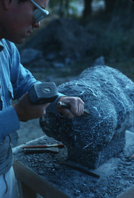 Close-up of Michael Prentice chiseling stone