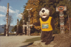 Tillicum in front of totem poles at Brockton Point