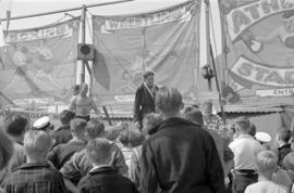 [Crowd in front of boxing and wrestling sideshow attraction]