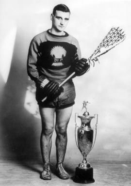[Clarence Jenion with a lacrosse trophy]