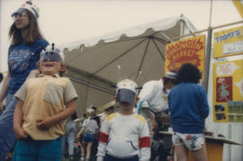 Children wearing masks outside of Imagination Market craft tent
