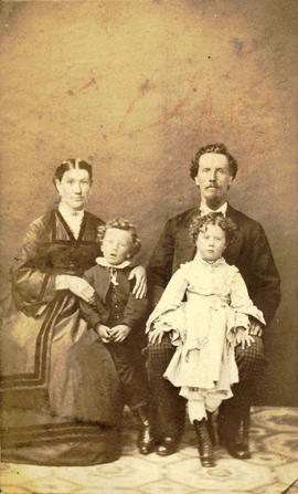 [Seated studio portrait of the Kily family, at the Kept Hotel in Barkerville]