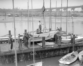 Mr. G.B. Warren, Pacific Motor Boat, loading yachts on scow [False Creek]