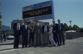 Group of men with Cats cast members in front of the Queen Elizabeth Theatre Bank of Montreal sign...