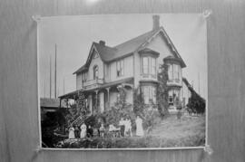 [Photograph of individuals outside of a house, 2 of 2]