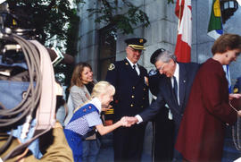 Girl Guide shaking hands with Roméo LeBlanc on City Hall steps