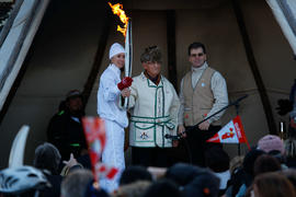 Day 33 Torchbearer 67 Stéphanie Ross carries the flame into a Community Stop in Essipit, Quebec.