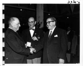 P.N.E. director G.S. Powell and Advisory Director P.H. Moore presenting award, likely at 1956 P.N...
