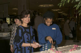 Unidentified woman serving cake at Legacies Program event at The Bay