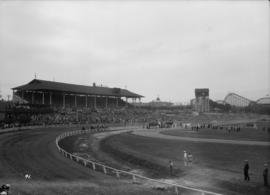 Canadian Pacific Exhibition - Horse racing  [Racing around the track, grandstand in the background]