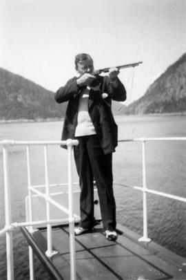 Eric W. Hamber with a firearm aboard the Vencedor