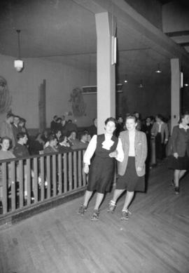 [Two women roller skating at Centre Gardens Roller bowl]