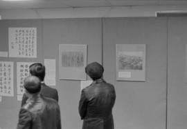 People looking at a historical photographs exhibit at the Chinese Cultural Centre Spring Festival