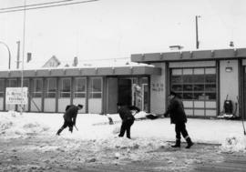 [Firefighters clearing snow in front of Firehall No. 20, Victoria Drive at 38th Avenue]