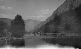 Man crossing a bridge on horseback