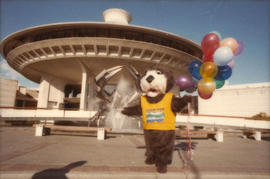 Tillicum holding balloons in front of the Vancouver Museum