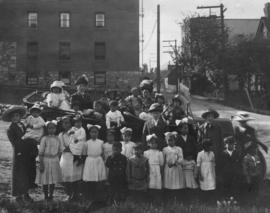Group of women and children in and around an automobile
