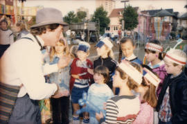 Balloon twister entertaining group of children